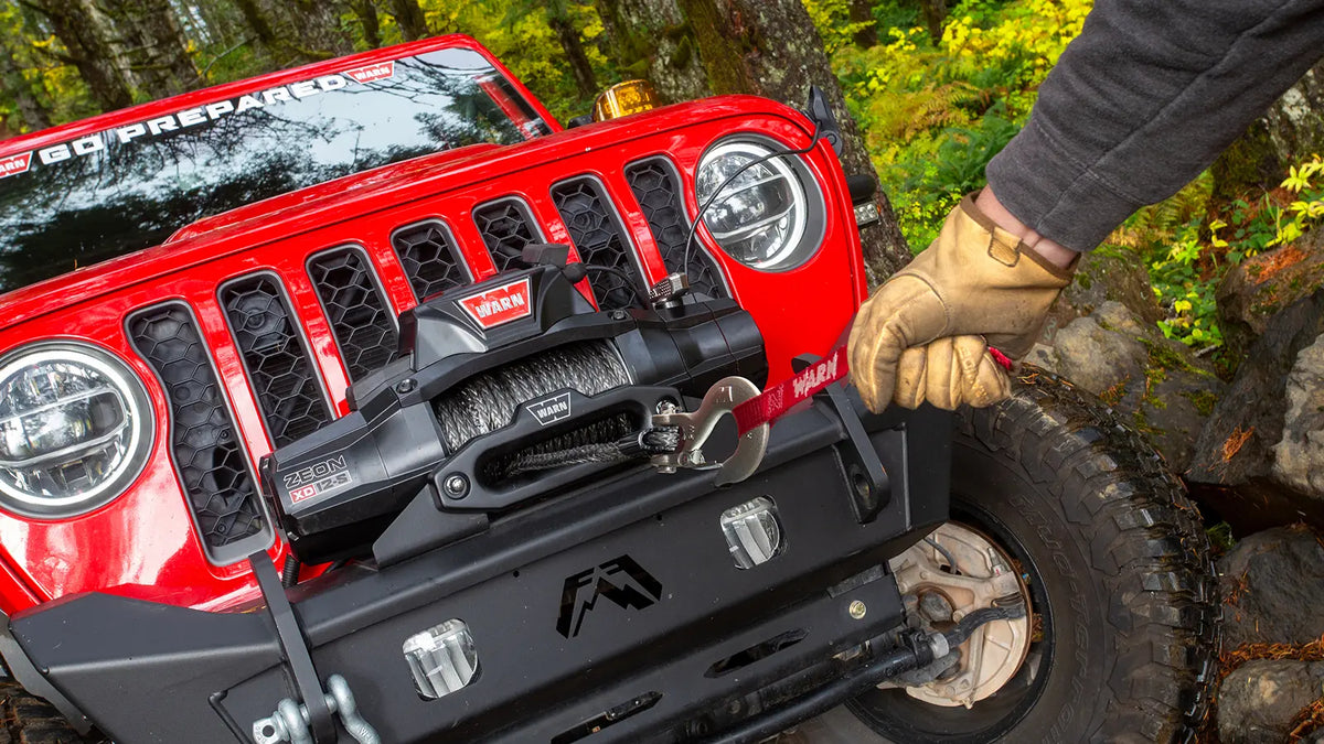 WARN ZEON XD 12-S 12,000 lb truck, Jeep, and SUV winch shown on a wooded trail