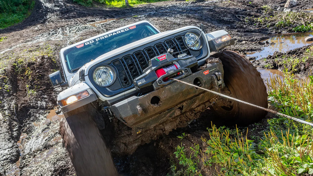 WARN ZEON XP 12-S 12,000 lb truck, Jeep, and SUV winch shown in muddy off-road terrain