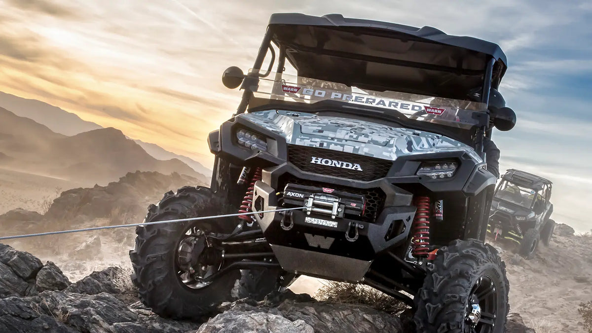 WARN AXON 35-S with Plow Mode shown in rocky off-road terrain