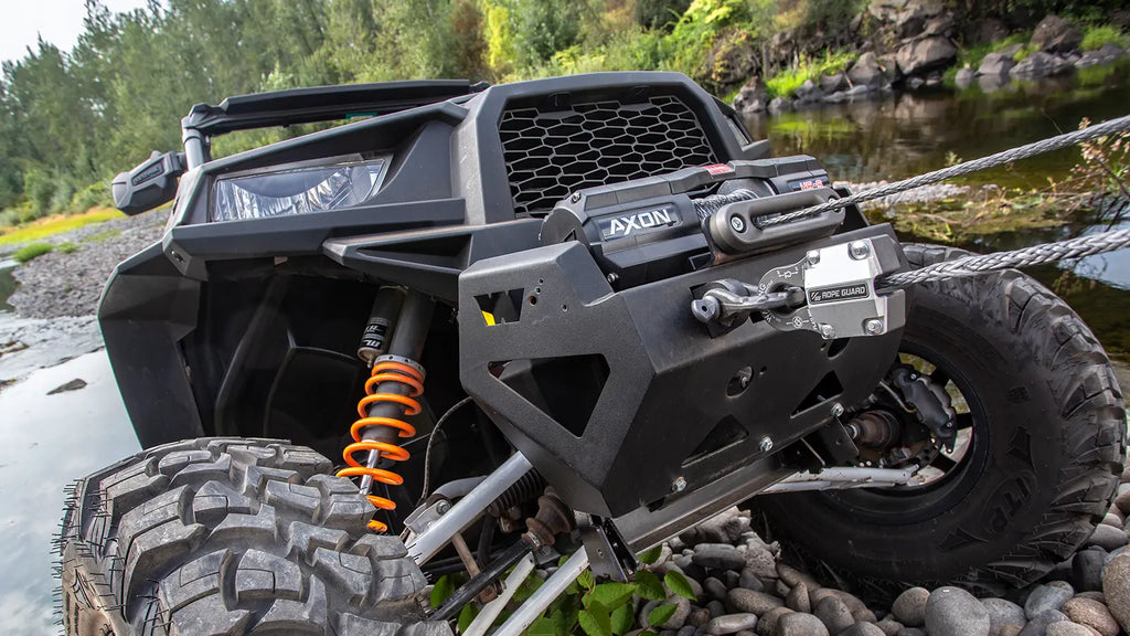 WARN AXON 45-S with Plow Mode shown on an off-road vehicle near a river